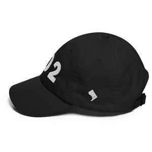 Black 202 area code hat with shape of Washington D.C. embroidered on the side. (Left side view)